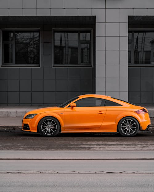 An Orange Coupe Parked on the Road