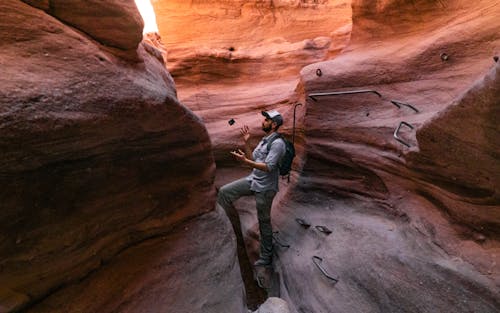 Free Man Standing in Cave of Canyon Stock Photo