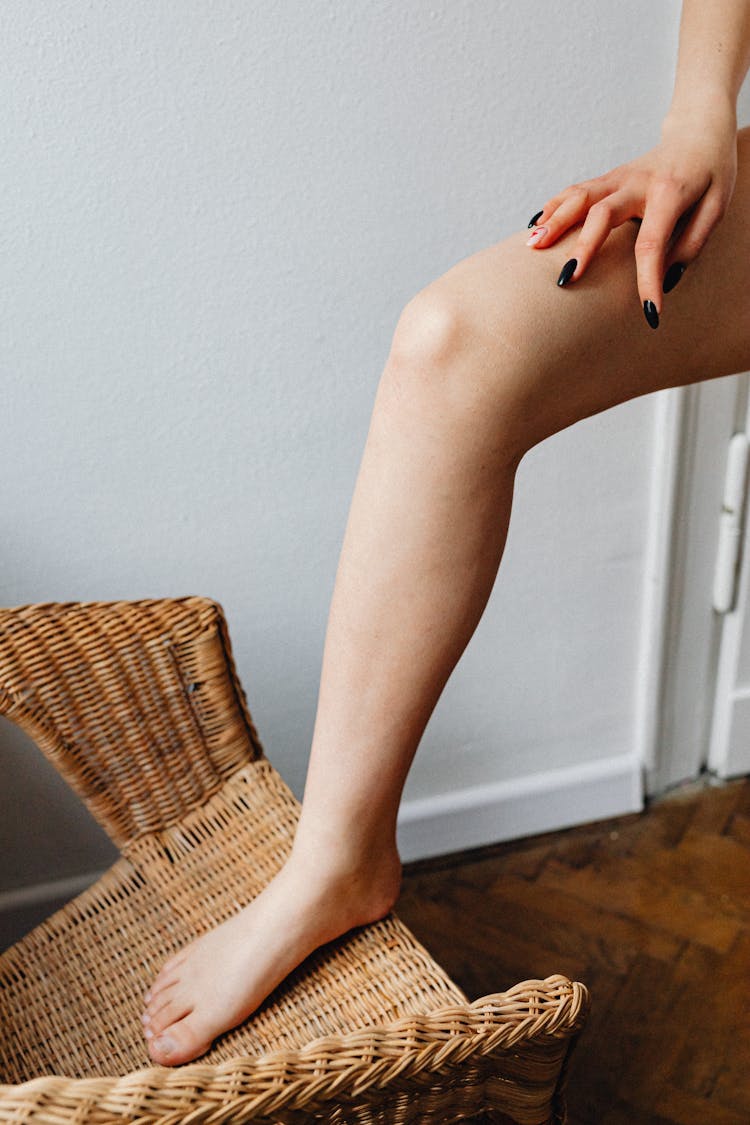 Woman's Leg On Woven Chair