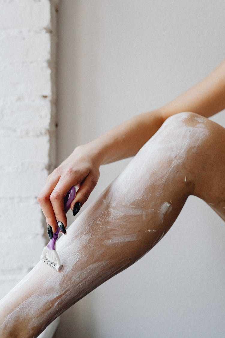 Female Hand Shaving Leg