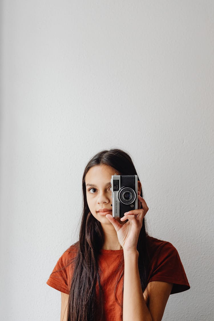 A Girl Holding An Olympus Camera