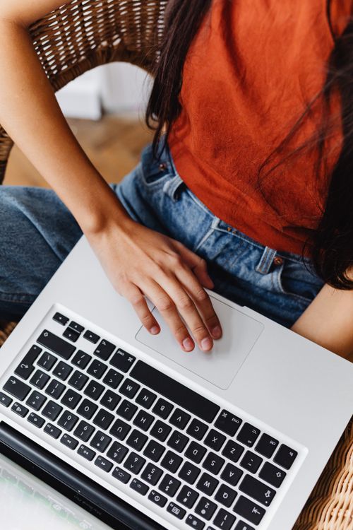 Free Close-up of woman using a laptop touchpad, emphasizing hand motion and modern technology. Stock Photo