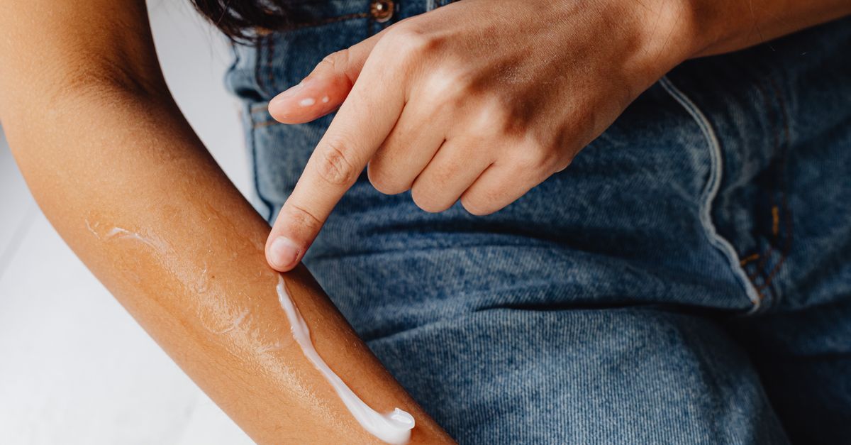 man applying lotion arm