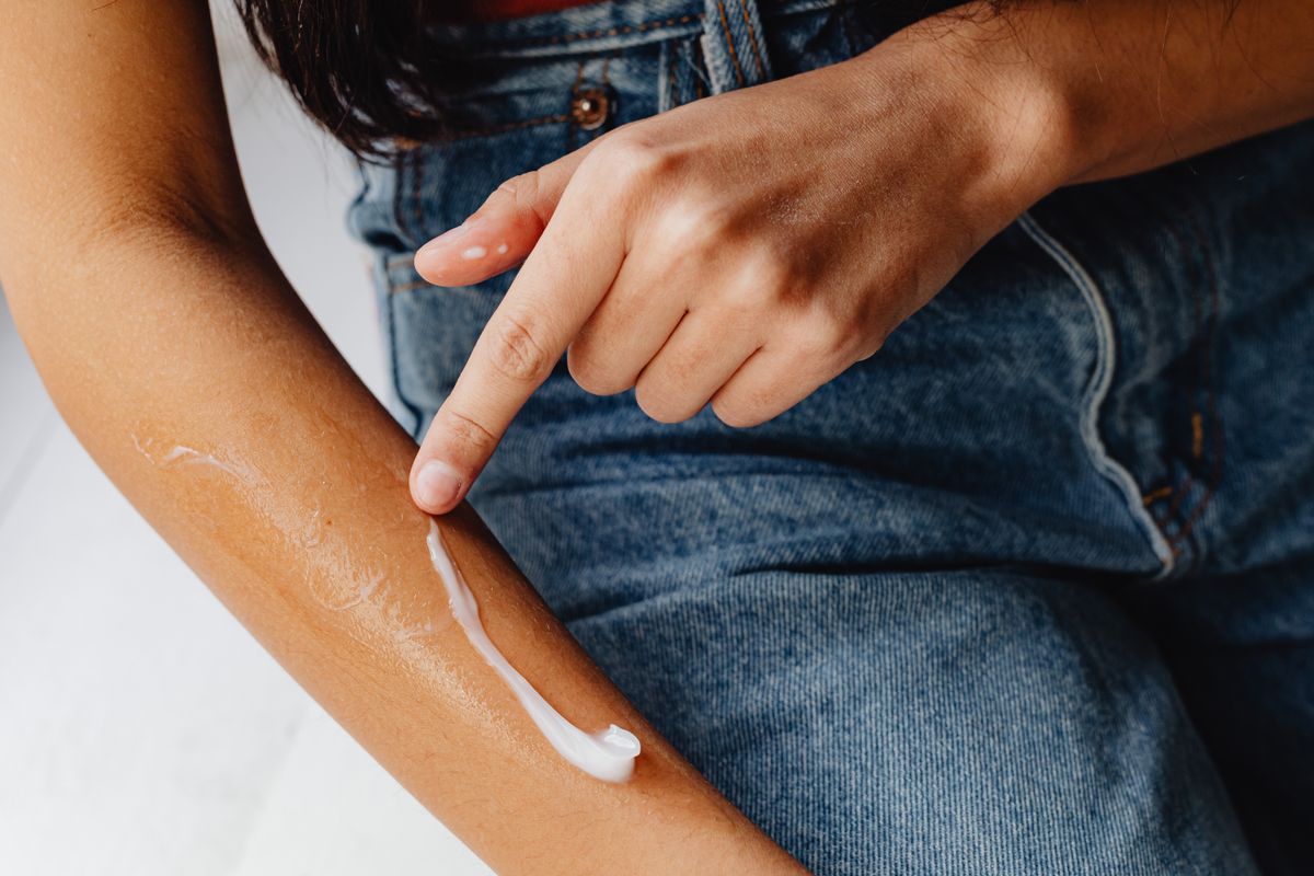 Applying RejuvaMark cream to skin