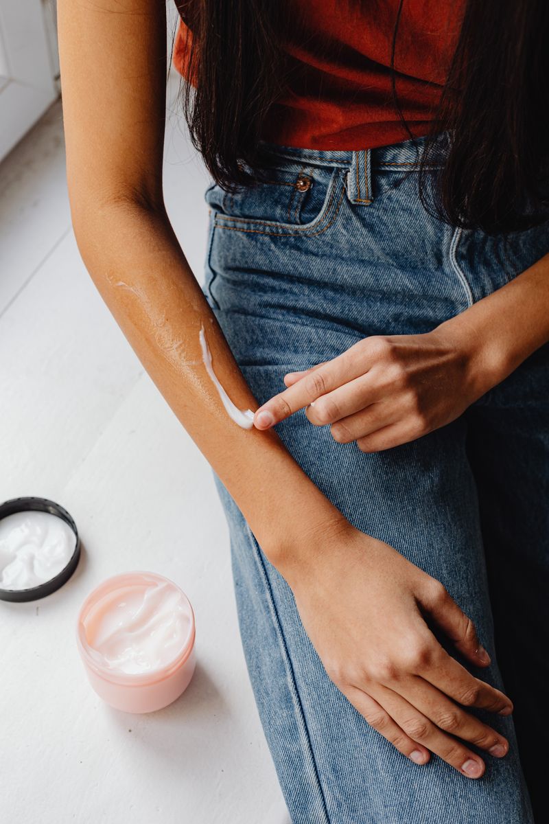 Person applying cream to skin representing transdermal magnesium application