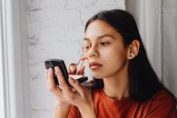 Girl Curling Lashes with Gold Eyelash Curler