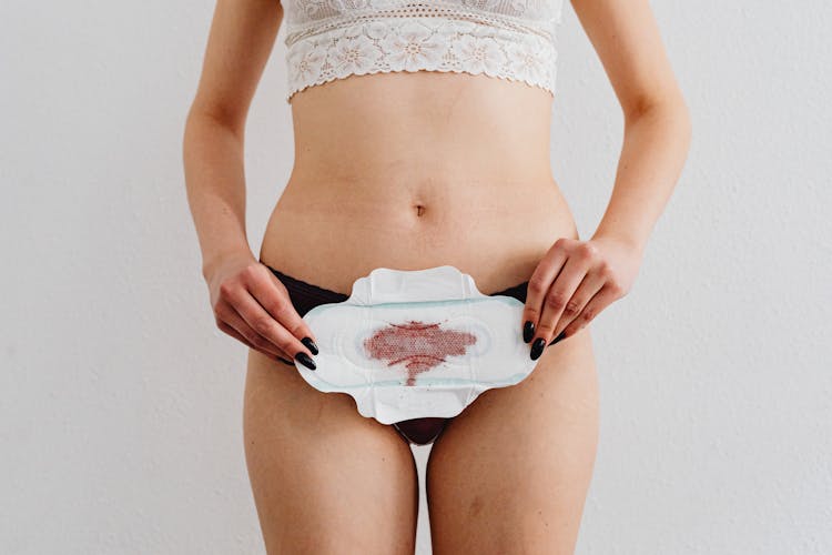 A Woman Holding A Menstrual Pad