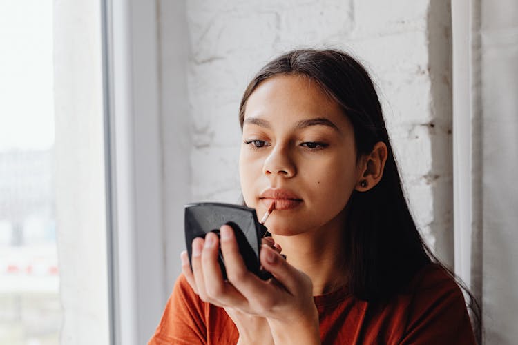 Pretty Woman Applying A Lip Tint