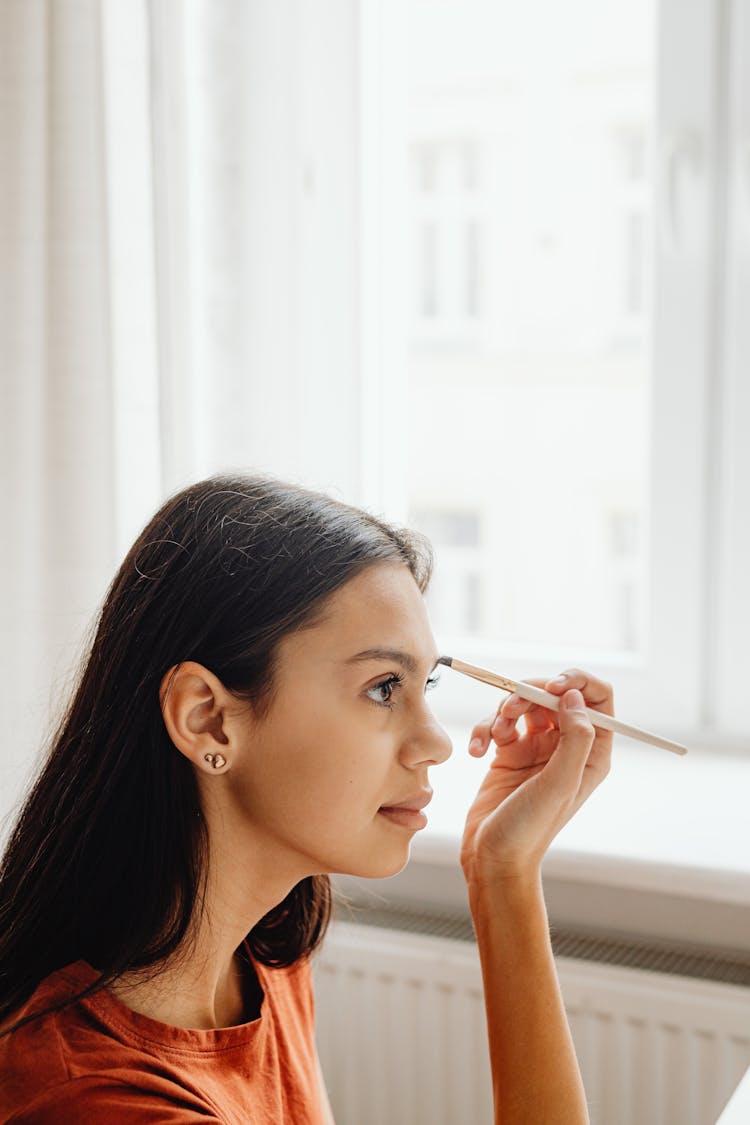 A Woman Applying An Eyebrow Liner