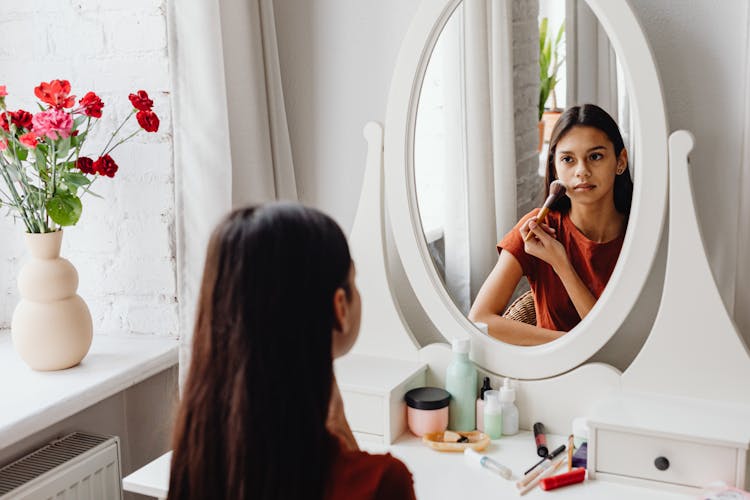 A Teenage Girl Putting On Makeup