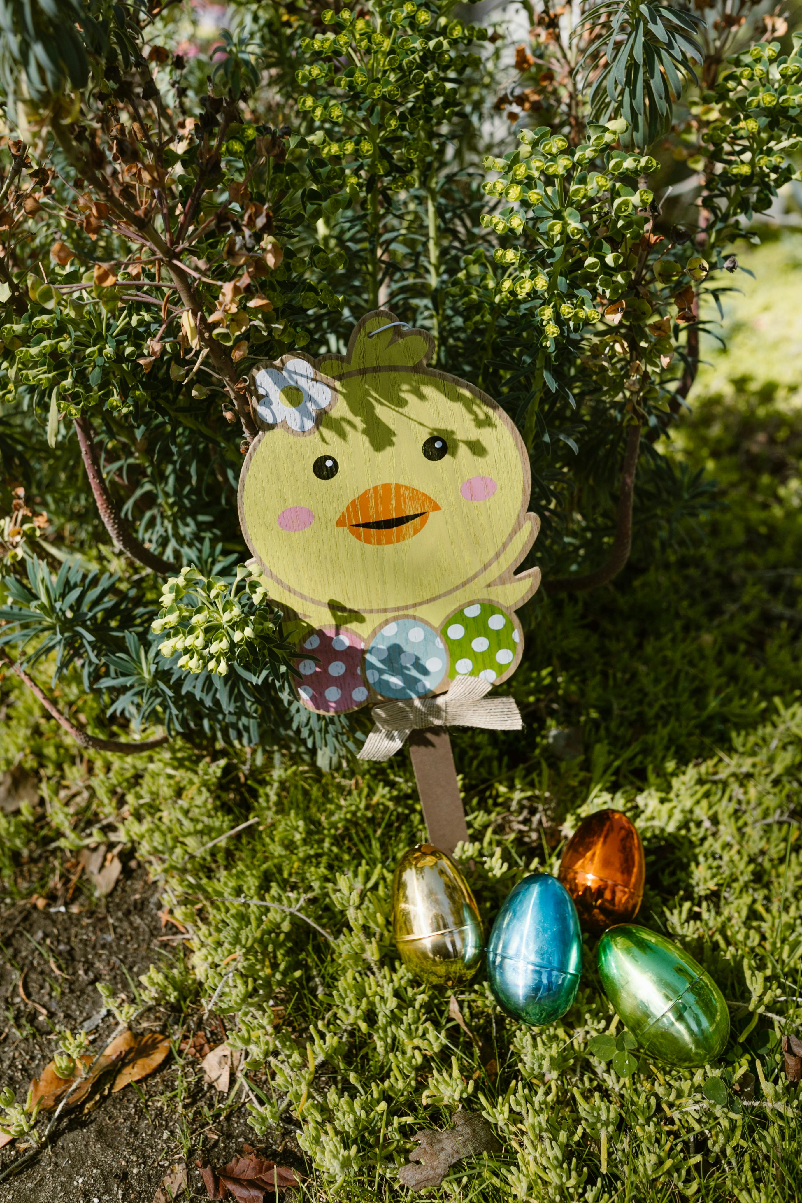 A cheerful Easter chick surrounded by vibrant eggs nestled among greenery, capturing the festive spirit.