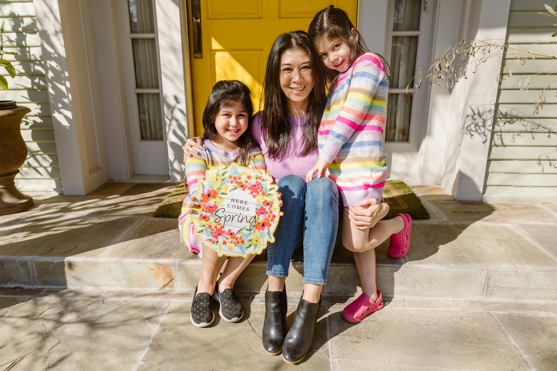 Happy family portrait on porch with vibrant spring theme.