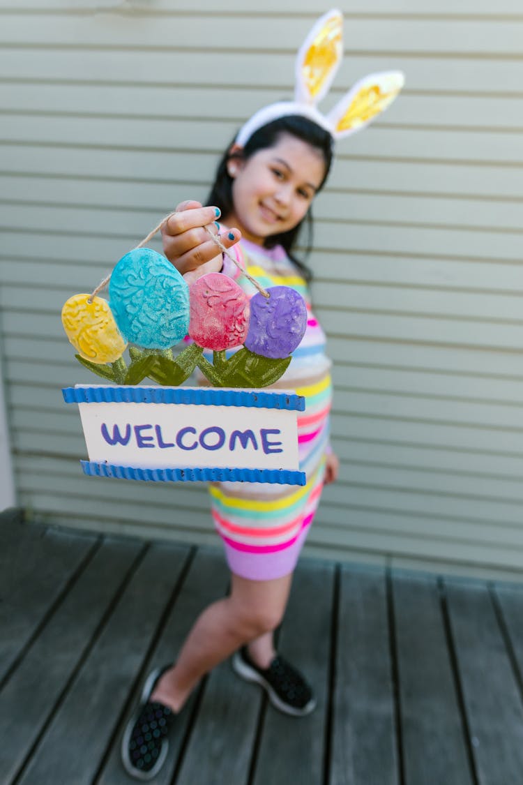 A Girl Holding A Welcome Sign