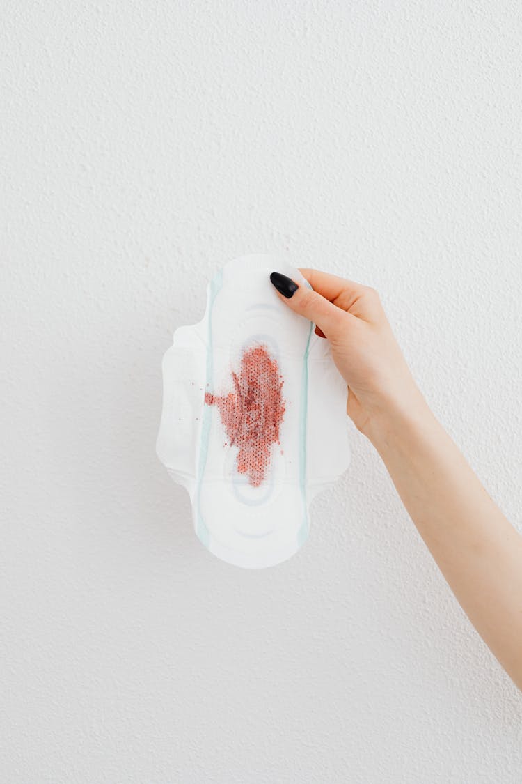 Person Holding A Sanitary Napkin