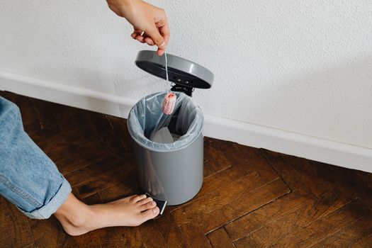 Person Throwing a Tampon in a Trash Bin