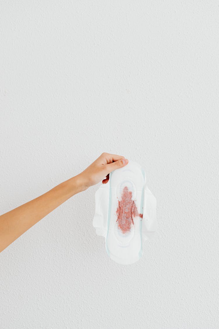 Person Holding A Sanitary Napkin