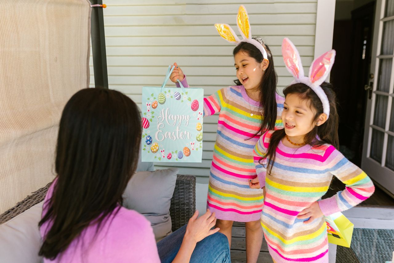 children enjoying easter with bunny ears and a festive gift bag indoor