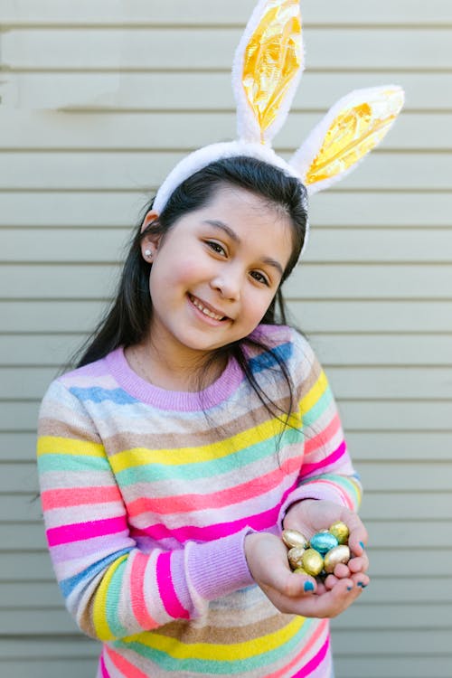 Free Smiling Girl Holding Tiny Easter Eggs Stock Photo