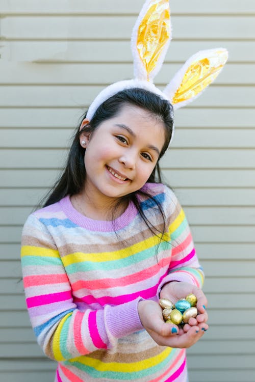 Smiling Girl Holding Tiny Easter Eggs