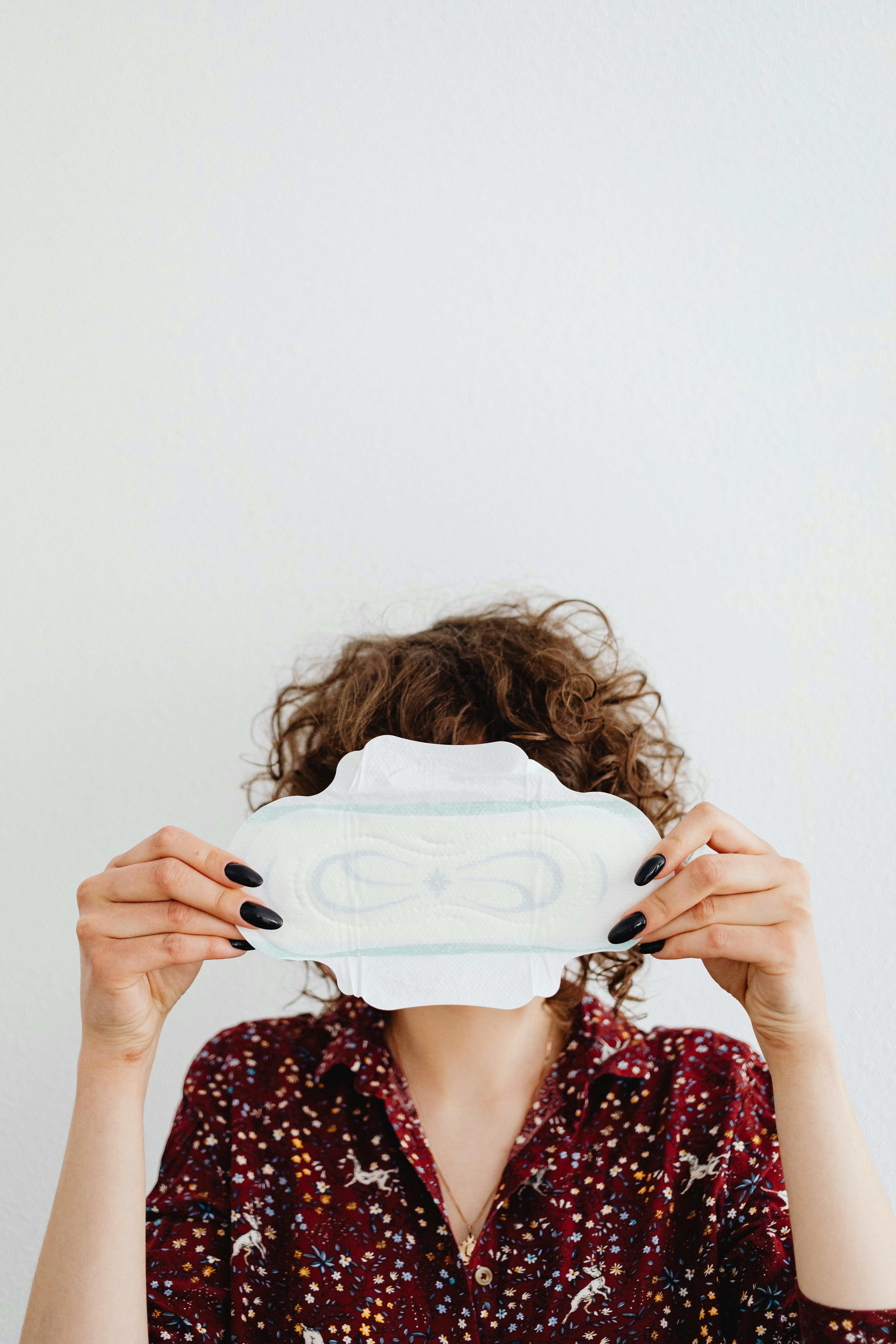 woman holding a sanitary napkin