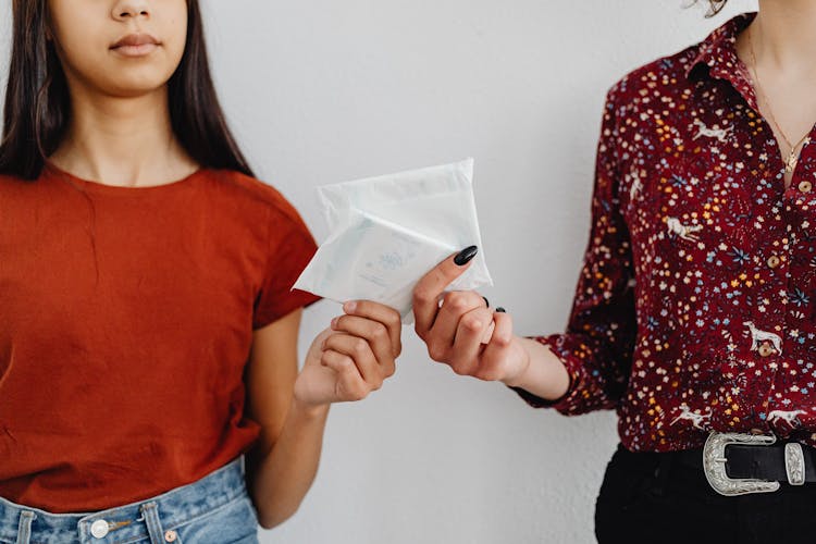 Women Holding Sanitary Napkins In A Pack