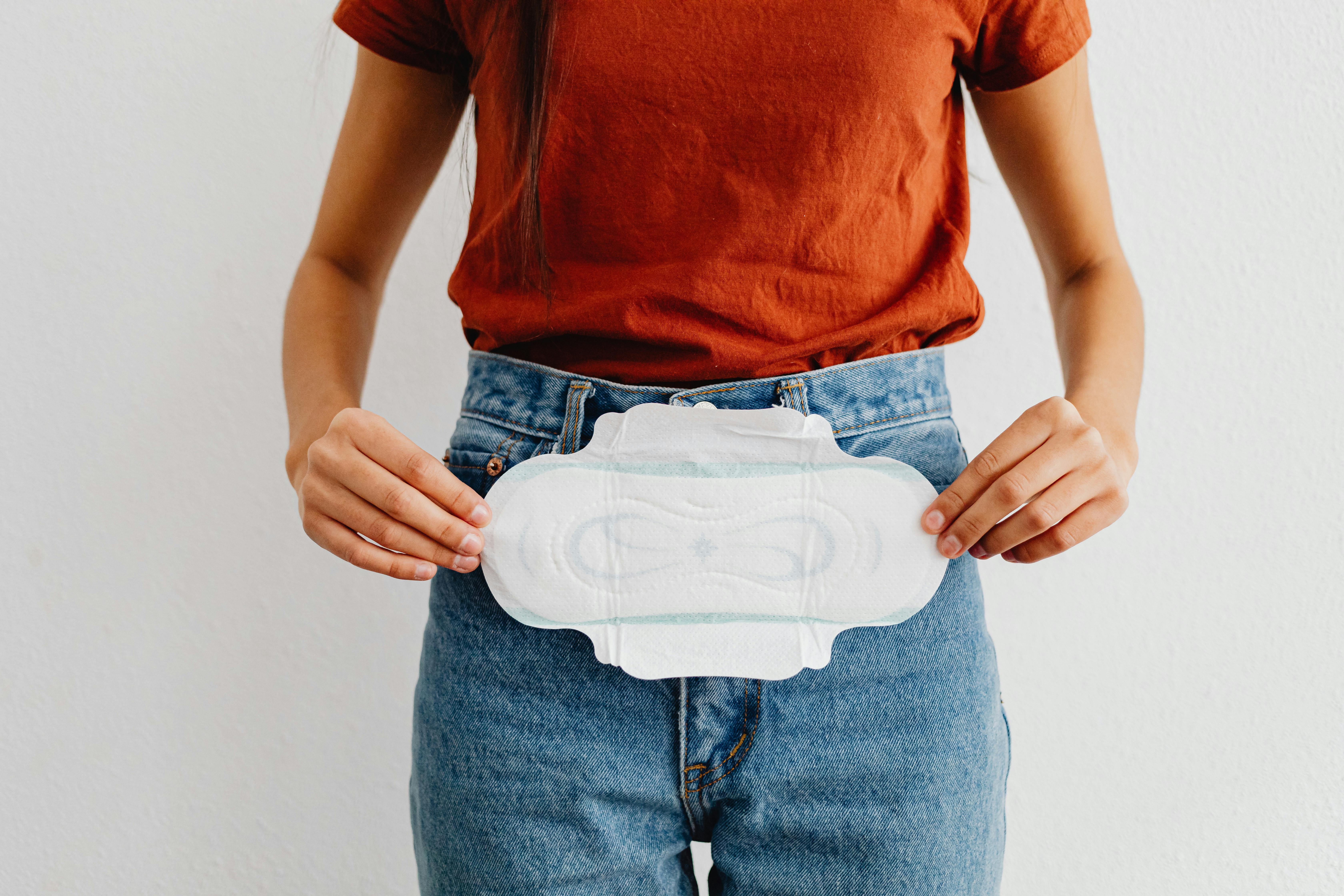 woman holding a sanitary napkin