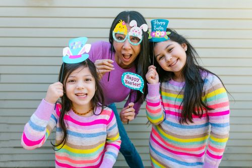 Free A mother and her daughters celebrate Easter with fun props and colorful sweaters, showcasing festive spirit. Stock Photo