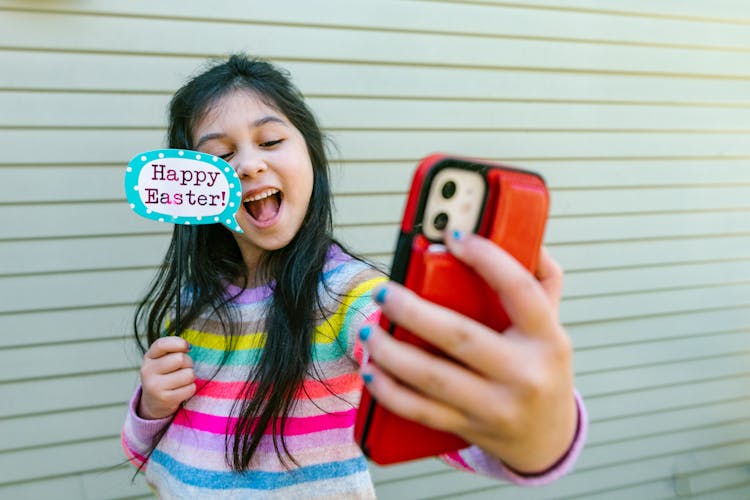 Cute Girl Holding An Easter Decor While Taking Selfie