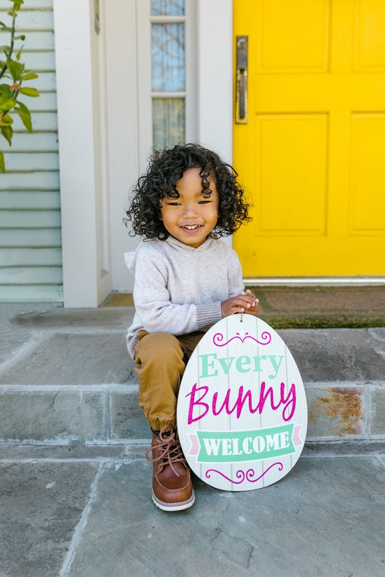 Smiling Girl Holding An Easter Greeting Card