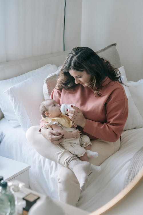 Free Mother feeding baby from bottle Stock Photo