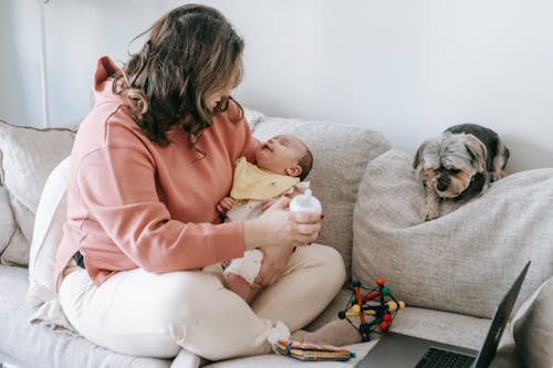 Free Faceless woman with little baby and dog Stock Photo