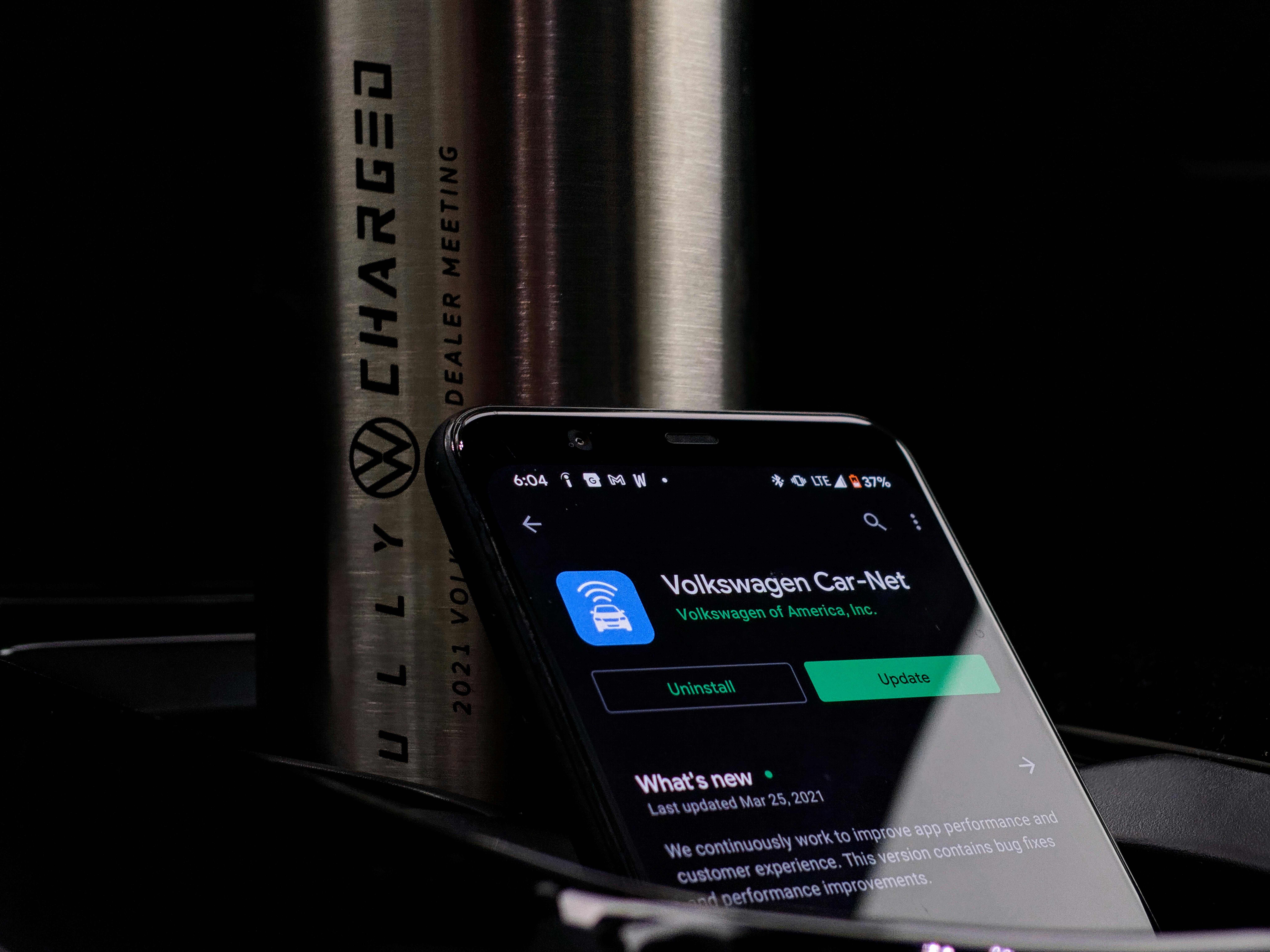 Pregnant woman smiling while holding her belly indoors