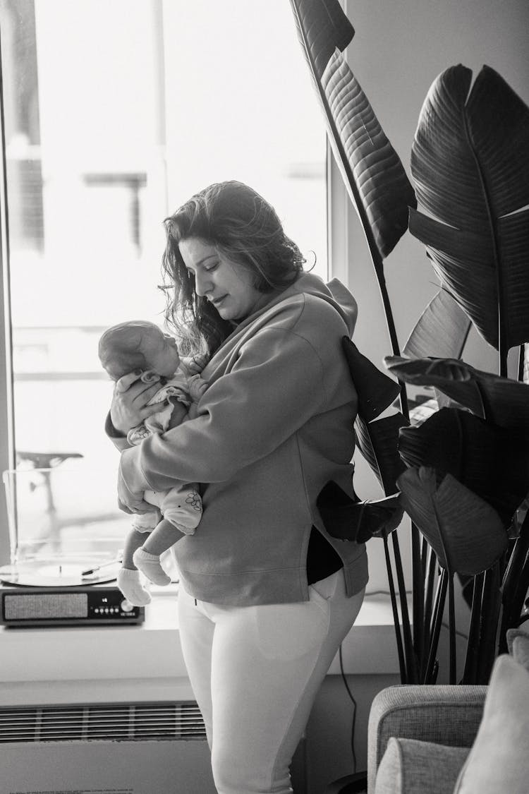 Mother With Baby Near Window