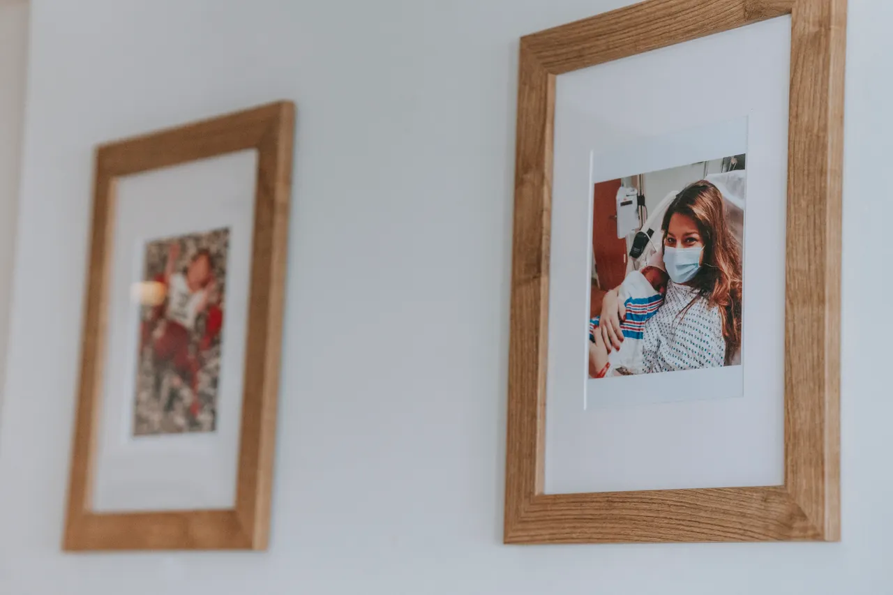 family-photos-above-couch Two framed portrait photographs hung side by side on a white wall