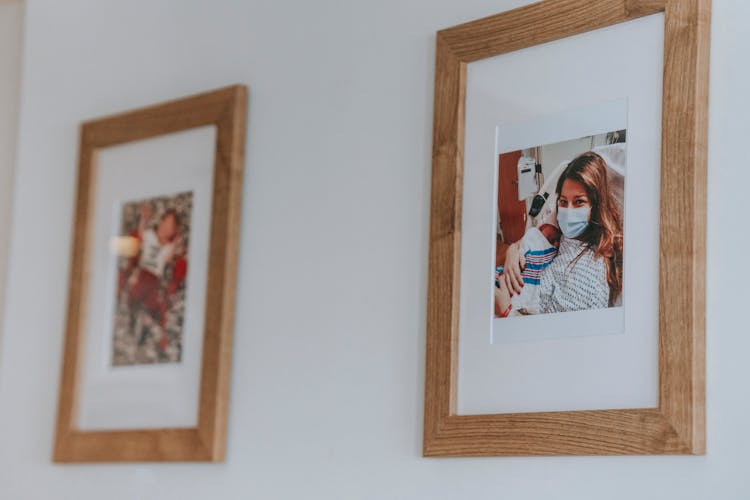 Framed Photo Of Mother And Newborn Baby Hanging On Wall