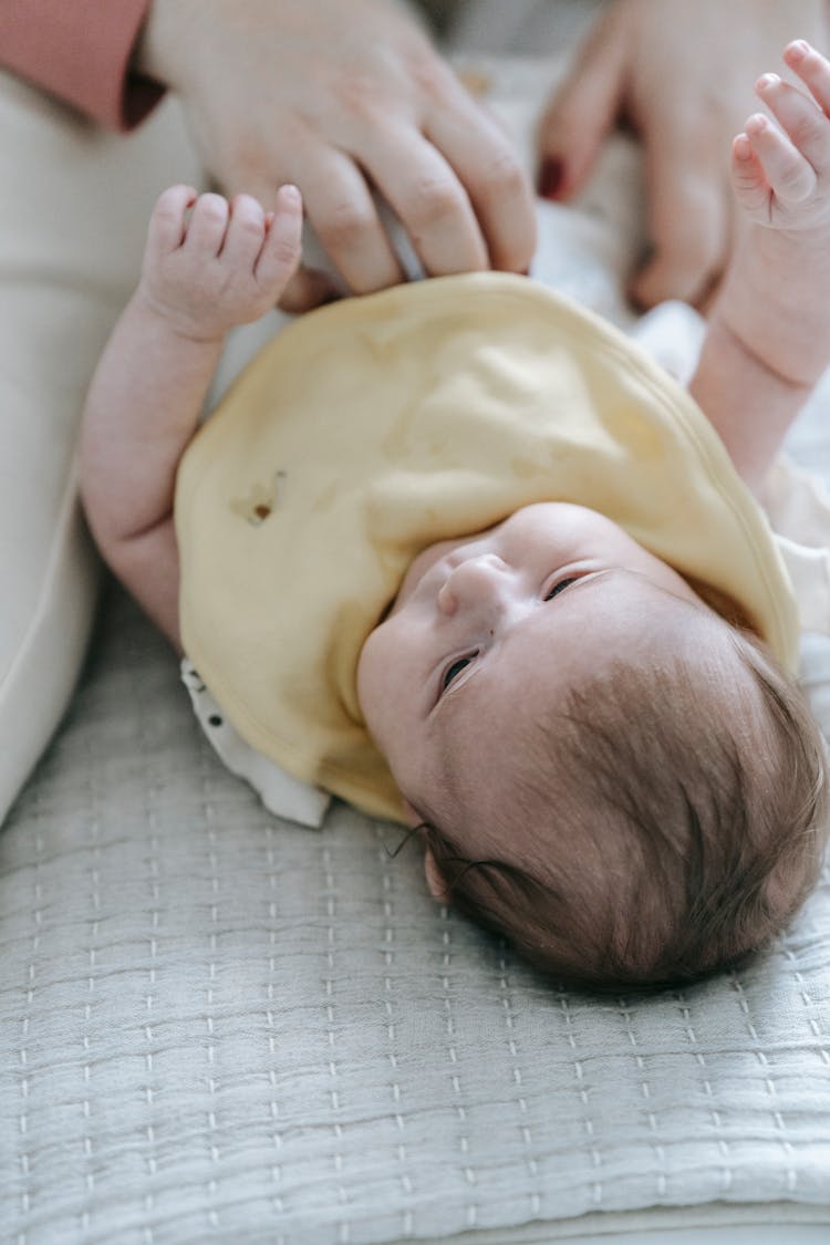 Crop Mom Changing Diaper Of Adorable Infant