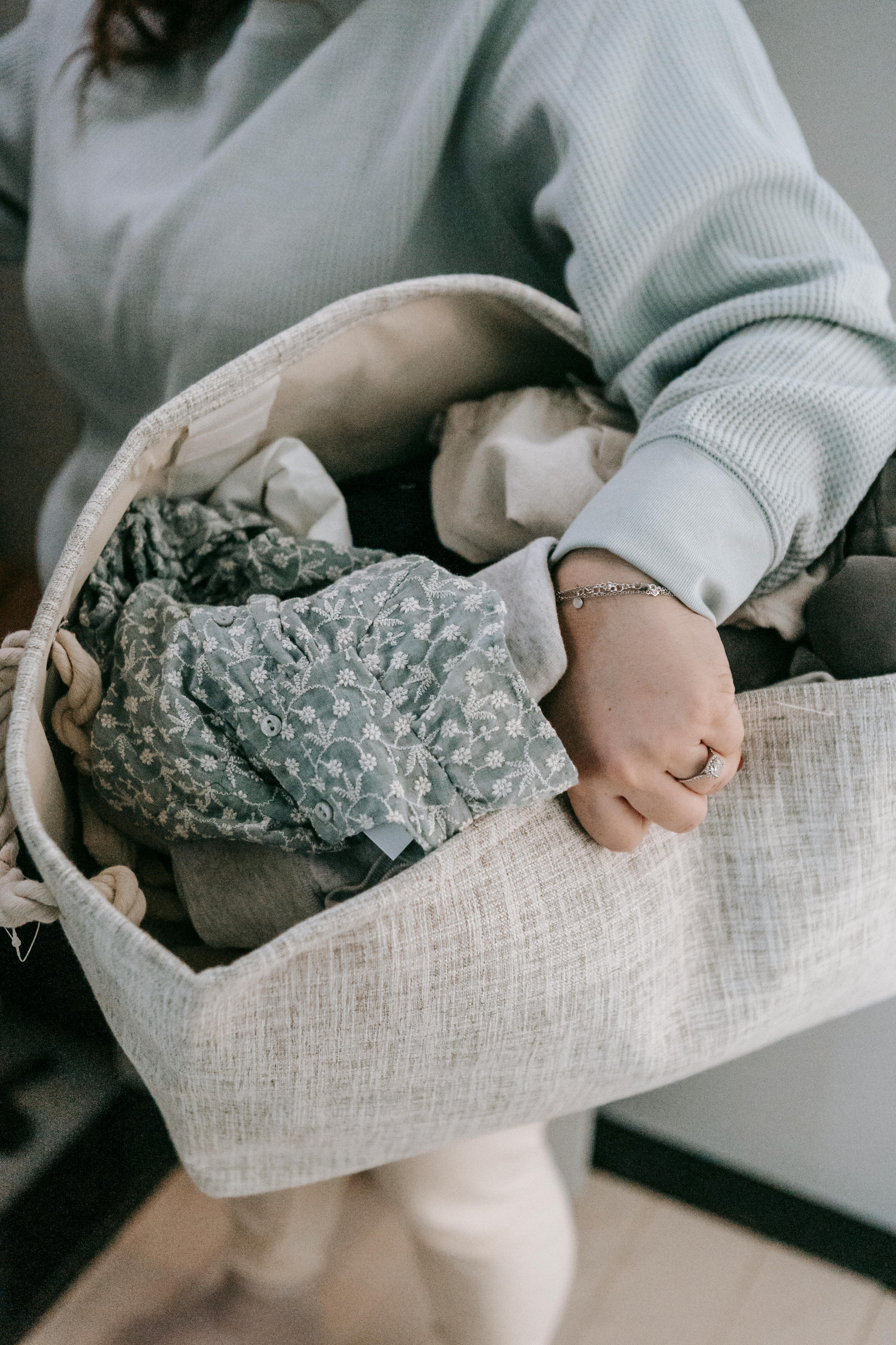 unrecognizable mother with laundry bag