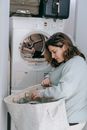 Woman choosing clothes for for washing