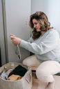 Woman choosing dirty clothes from basket