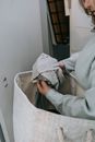 Unrecognizable woman choosing dirty clothes