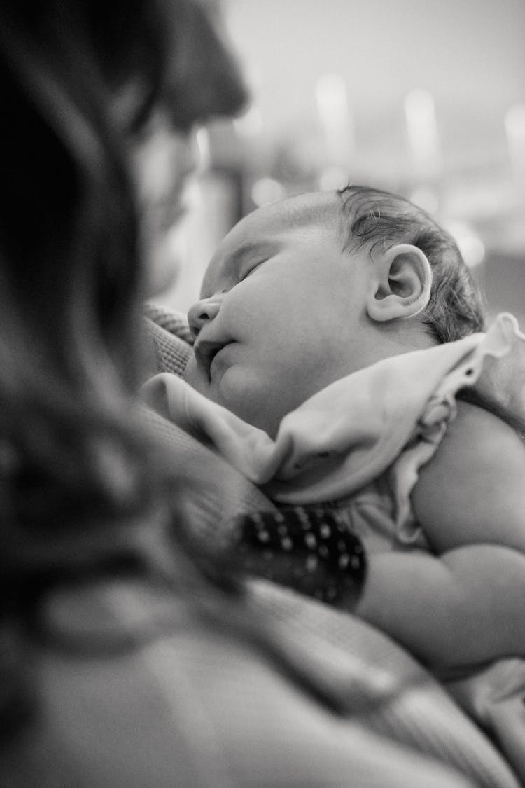 Faceless Mother With Sleeping Newborn Baby