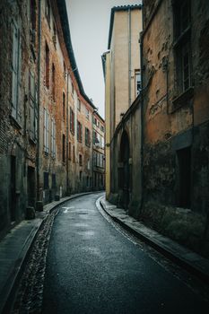 Explore the narrow, historic streets of Toulouse, France, showcasing rustic buildings and a serene atmosphere.