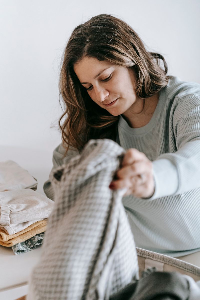 Hands folding clean fresh-smelling laundry