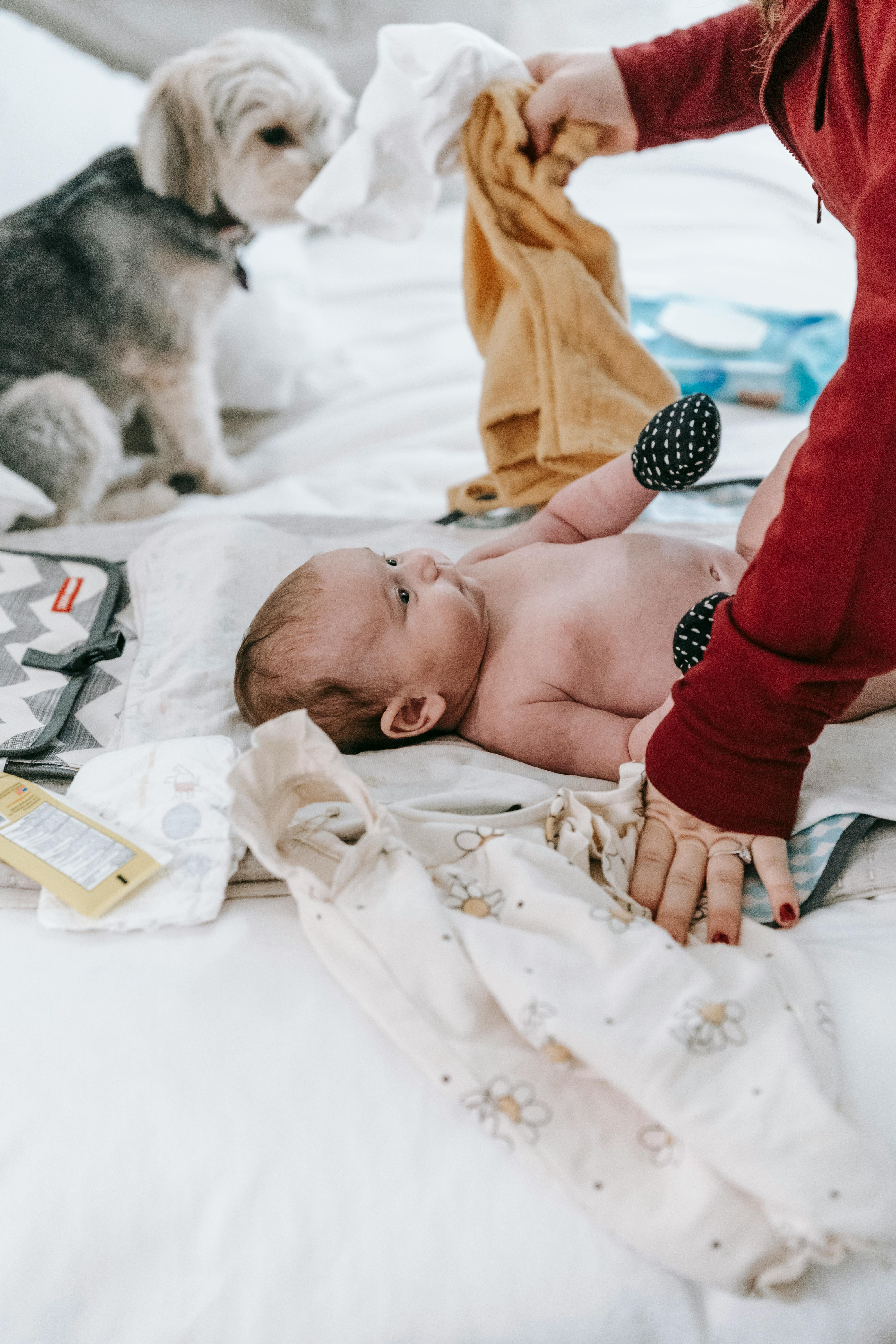 faceless mother changing clothes to baby