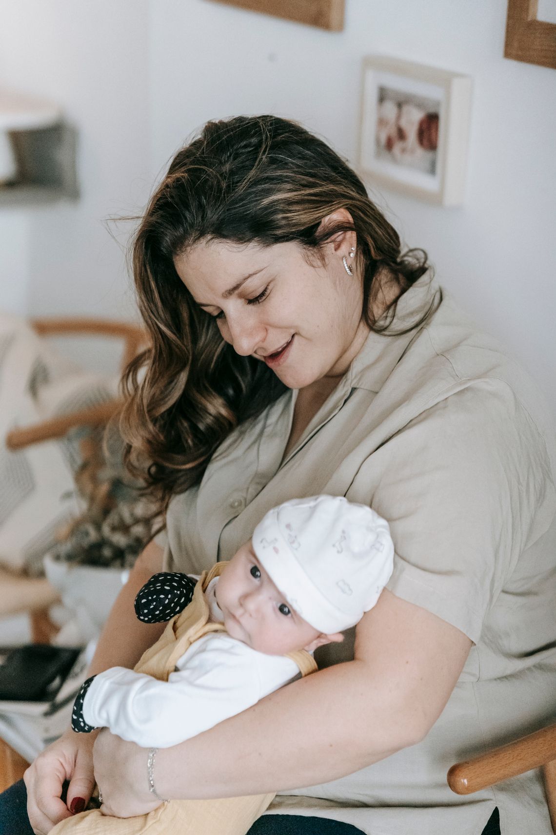Mother gently holding her newborn baby at home