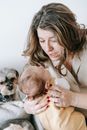 Mother looking down at infant in hands