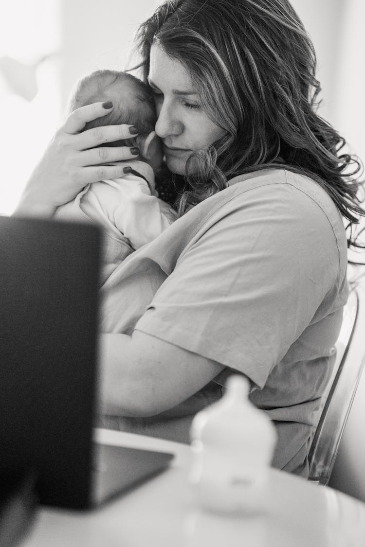 Female Freelancer Mom Caring Infant During Work