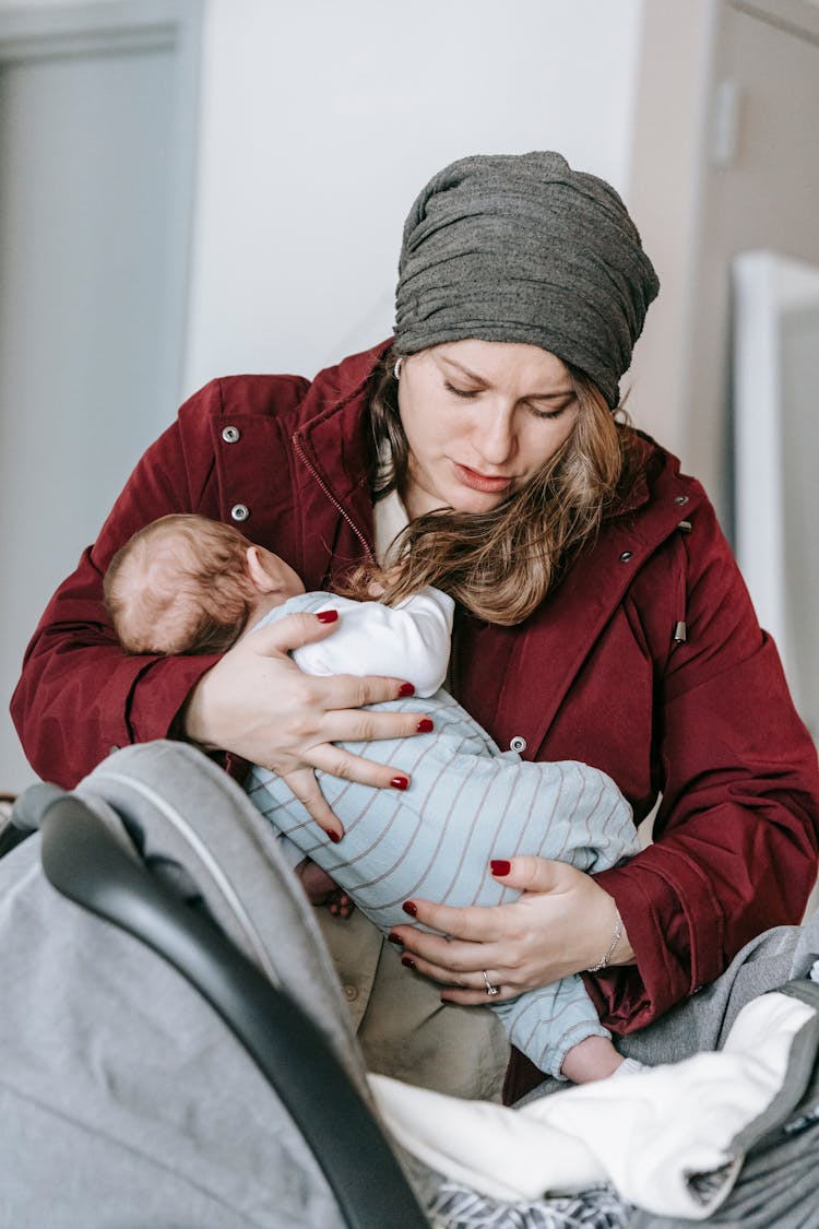 Mom Placing Baby In Carriage