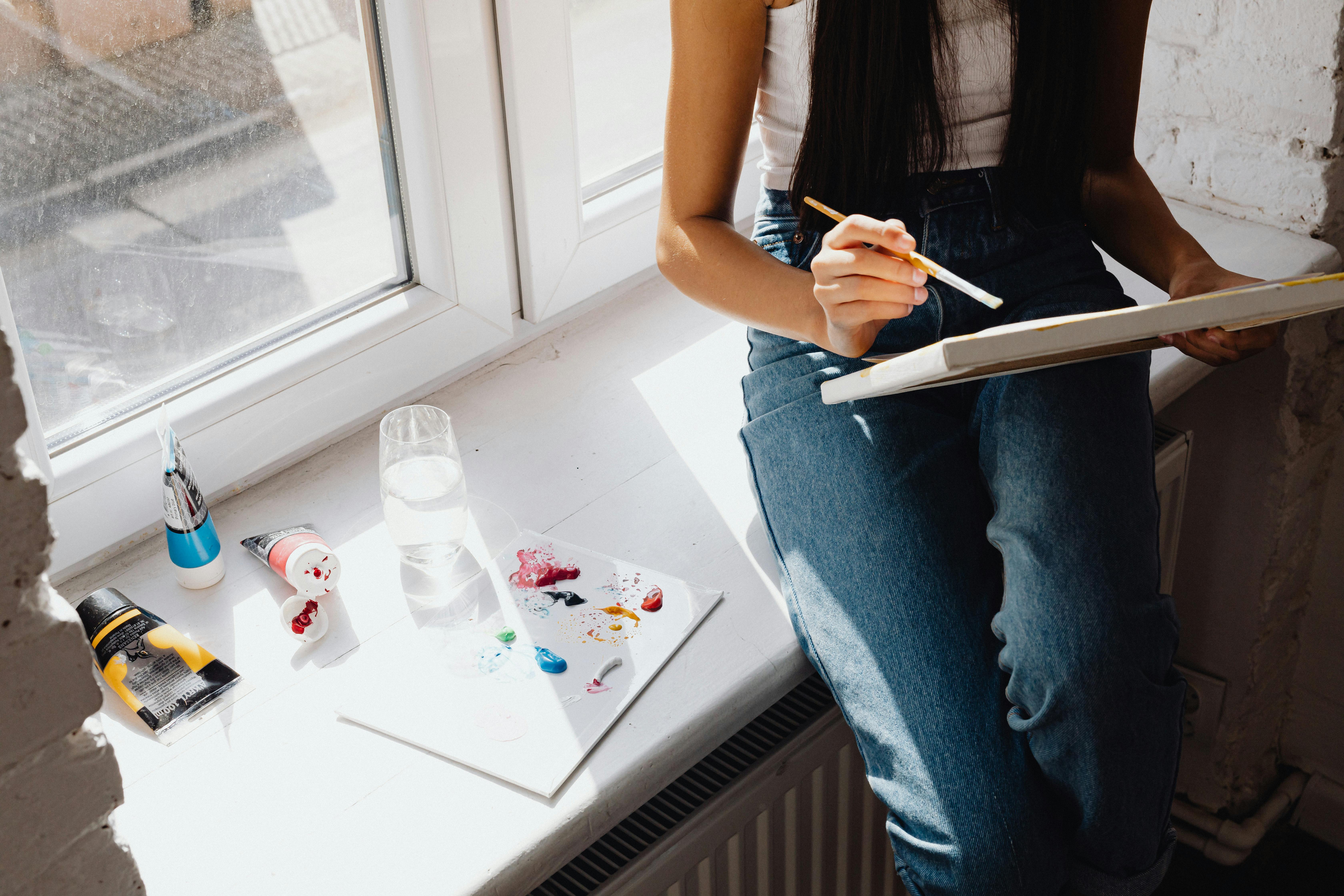 a girl painting while sitting