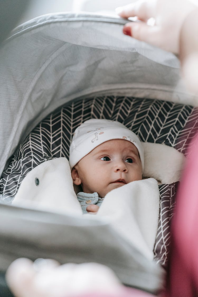 Baby In Carriage Looking At Crop Mom